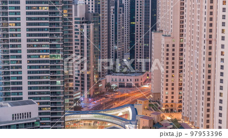 Overview to JBR and Dubai Marina skyline with modern high rise skyscrapers waterfront living apartments aerial night to day timelapse Overview to JBR and Dubai Marina skyline with modern high rise skyscrapers waterfront living apartments aerial night to day timelapse 97953396