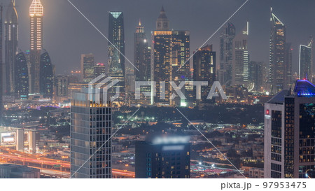 Rows of skyscrapers in financial district of Dubai aerial day to night timelapse. Rows of skyscrapers in financial district of Dubai aerial day to night timelapse. 97953475