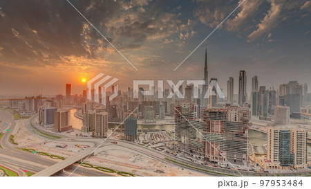 Skyline with modern architecture of Dubai business bay towers at sunset timelapse. Aerial view 97953484