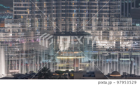 Dubai Fountain aerial night timelapse. Musical fountain, located in an artificial lake in downtown Dubai Fountain aerial night timelapse. Musical fountain, located in an artificial lake in downtown 97953529