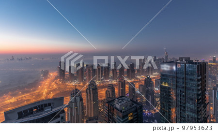 Panorama of Dubai Marina with JLT skyscrapers and golf course night to day timelapse, Dubai, United Arab Emirates. 97953623