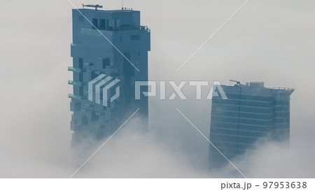 Fog covered JLT skyscrapers and marina towers near Sheikh Zayed Road aerial timelapse during sunrise. Residential buildings Fog covered JLT skyscrapers and marina towers near Sheikh Zayed Road aerial timelapse during sunrise. Residential buildings 97953638