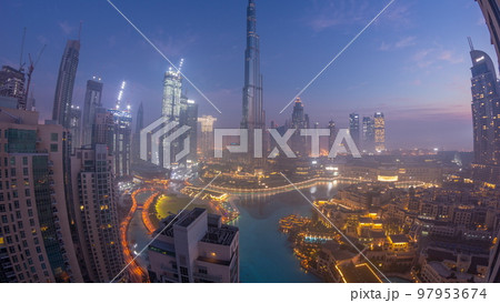 Aerial view of Dubai city early morning during fog night to day timelapse. 97953674