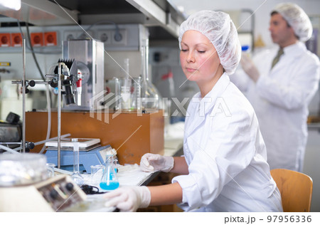 Young adult woman lab technician at work Young adult woman lab technician at work 97956336