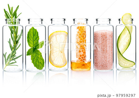 Homemade skin care with natural ingredients rosemary ,cucumber slice ,himalayan salt ,honeycomb ,lemon slice and mint leaves in glass bottles isolate on white background. 97959297