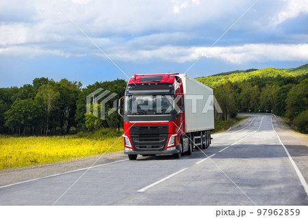 Red truck on a road in summer Red truck on a road in summer 97962859