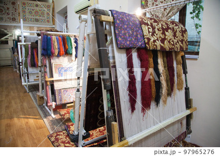 Weaving looms for hand-weaving carpets with multi-colored threads in Bukhara in Uzbekistan.. 05.05.2019 Weaving looms for hand-weaving carpets with multi-colored threads in Bukhara in Uzbekistan.. 05.05.2019 97965276
