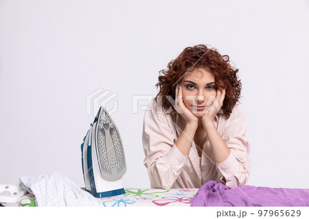 Boring household chores. Pause while ironing men's shirts. Boring household chores. Pause while ironing men's shirts. 97965629