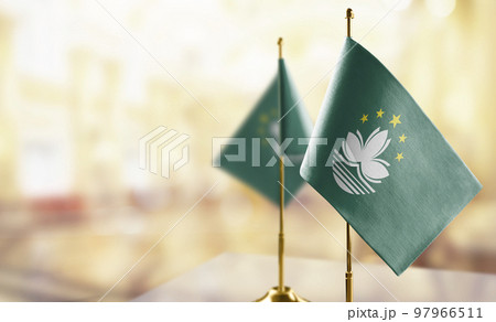 Small flags of the Macao on an abstract blurry background Small flags of the Macao on an abstract blurry background 97966511