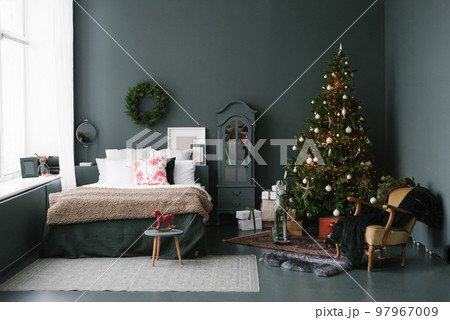 Decorated christmas tree to basket stands in dark vintage bedroom 97967009