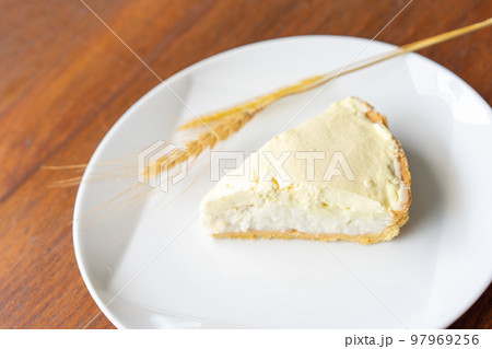 Clear Coconut Cream Pie in the dish on the wood table without anything topping on it. Shooting in the sunlight. Clear Coconut Cream Pie in the dish on the wood table without anything topping on it. Shooting in the sunlight. 97969256