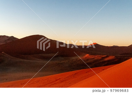 Climbing Dune 45 at sunrise 97969683