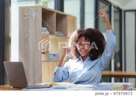 Black businesswoman work on laptop feel euphoric winning. Excited female triumph get good news from work 97970672