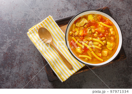 Rancho canario a typical Canary Islands dish with chickpeas and noodles closeup on the plate. Horizontal top view 97971334