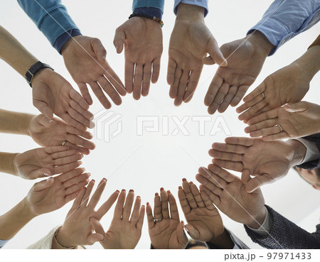 Diverse people form circle of hands demonstrating equality, unity and solidarity. 97971433