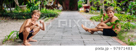Boy blond freckles squatting sit smiling show gesture thumbs up shirtless bare chested shorts nature 97971483
