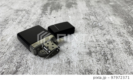 Petrol lighter lies on a light surface Petrol lighter lies on a light surface 97972371