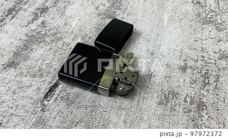 Petrol lighter lies on a light surface Petrol lighter lies on a light surface 97972372