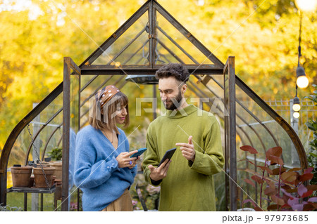Stylish couple hang out in garden Stylish couple hang out in garden 97973685