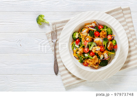 fried chicken tenders broccoli salad in bowl 97973748