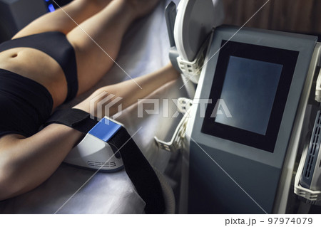 Woman getting treatment on buttocks to burn fat, build muscles and remove cellulite. 97974079