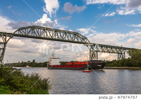 Cargo ship passing under Hochdonn railroad bridge on Kiel Canal, Schleswig-Holstein, Germany 97974707