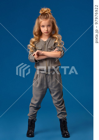 Little girl with a long curly hair in a fashionable clothes 97976922