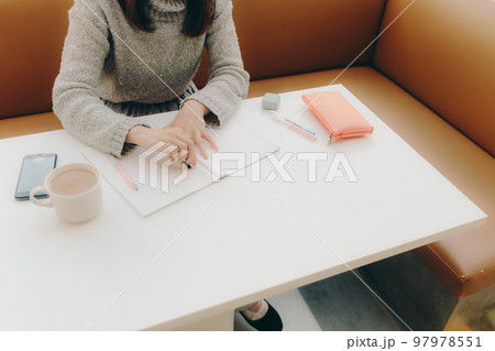 カフェで勉強をする若い女子大生の写真 97978551