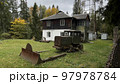 Old wooden houses in the forest and tractor in autumn, Carpathian Ukraine 97978784