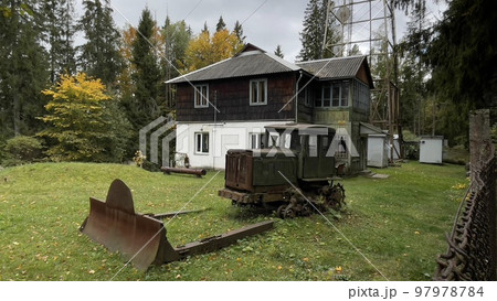 Old wooden houses in the forest and tractor in autumn, Carpathian Ukraine Old wooden houses in the forest and tractor in autumn, Carpathian Ukraine 97978784