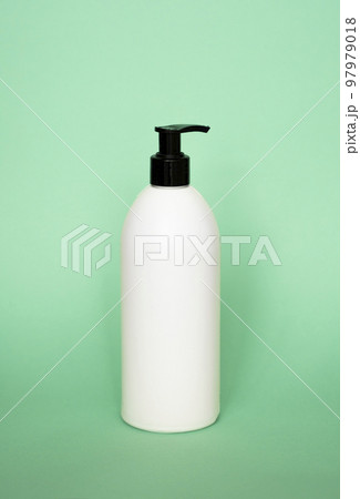 White plastic soap with black dispenser pump bottle on pastel green background. Skin care lotion, shampoo bottle, bath and body lotion. Bathroom accessories. 97979018