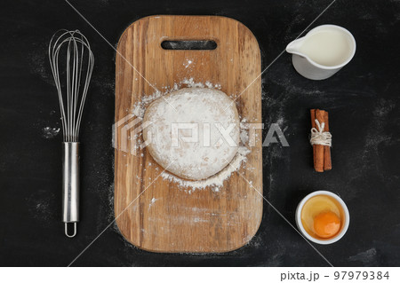 Flat lay composition with raw eggs and other ingredients on black background. Baking pie Flat lay composition with raw eggs and other ingredients on black background. Baking pie 97979384