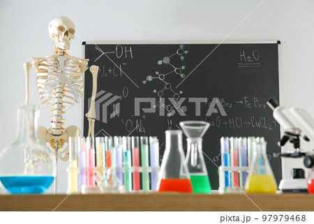 Different chemistry glassware and skeleton in classroom 97979468