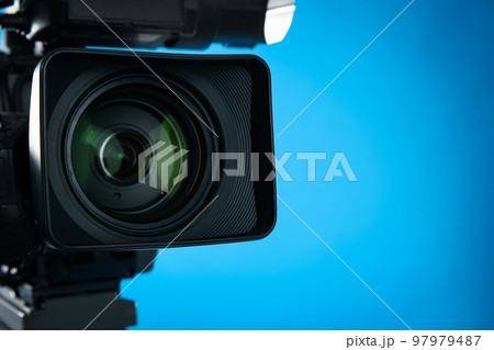 Professional video camera on blue background, closeup. Space for text Professional video camera on blue background, closeup. Space for text 97979487