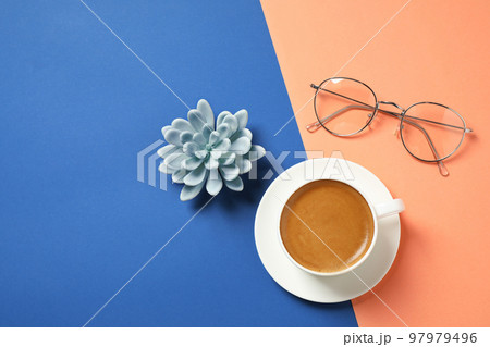 Flat lay composition with classic black coffee on blue and orange background. Color of the year 2020 97979496