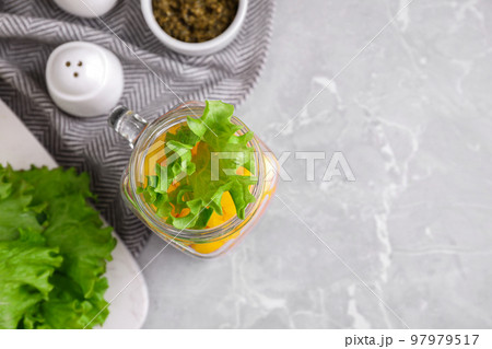 Healthy salad in glass jar on marble table, flat lay. Space for text Healthy salad in glass jar on marble table, flat lay. Space for text 97979517