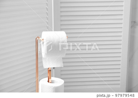 Holder with toilet paper rolls in bathroom 97979548