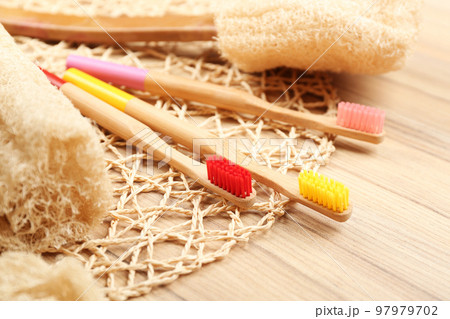 Natural toothbrushes made with bamboo on wooden table 97979702