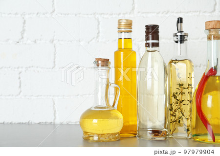 Different cooking oils on grey table. Space for text 97979904
