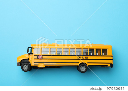 Yellow school bus on light blue background, top view with space for text. Transport service Yellow school bus on light blue background, top view with space for text. Transport service 97980053