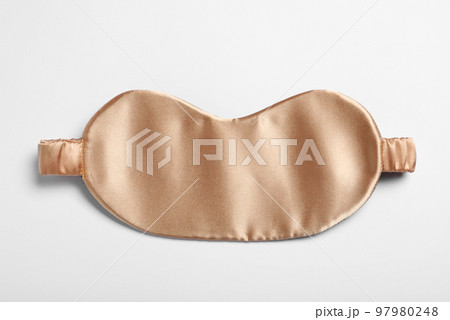 Beige sleeping mask isolated on white, top view. Bedtime accessory Beige sleeping mask isolated on white, top view. Bedtime accessory 97980248