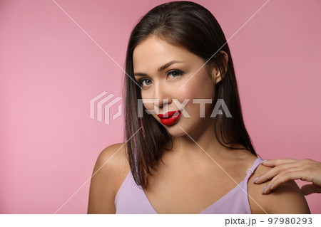 Beautiful woman with red lipstick on pink background Beautiful woman with red lipstick on pink background 97980293