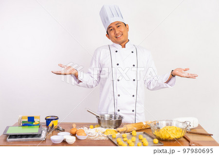 male chef with a questioning gesture behind the kitchen counter 97980695