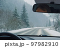 Driving through the winter snowy forest 97982910