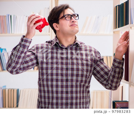 Young student in expensive textbooks concept Young student in expensive textbooks concept 97983283