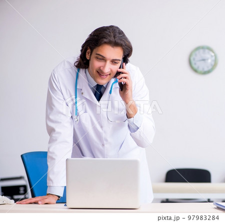 Young handsome doctor in telemedicine concept 97983284
