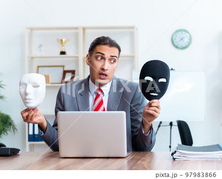 Businessman wearing mask in hypocrisy concept 97983866