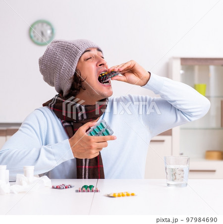 Young man suffering from flu at home Young man suffering from flu at home 97984690