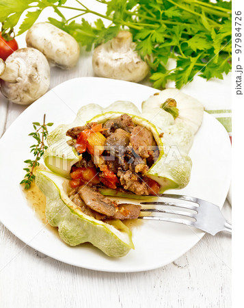 Patisson stuffed with liver and mushrooms in plate on board 97984726