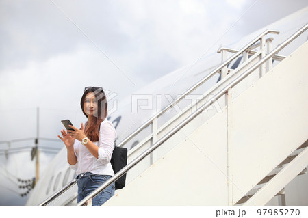 Traveling and Business concept,woman take photo when she walkimg in to the plane Traveling and Business concept,woman take photo when she walkimg in to the plane 97985270
